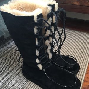 Black lace up UGG boots.